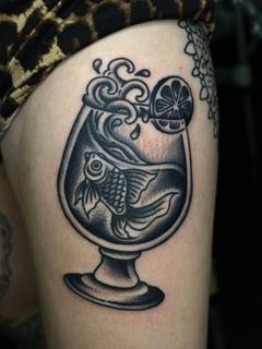 Blackwork fish in glass tattoo by @hudsontattoo
