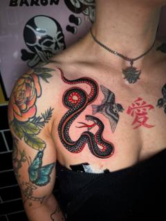 Traditional red and black snake tattoo by @alberto_sagripanti