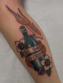 Traditional flaming bottle tattoo by @bratbabytattoo