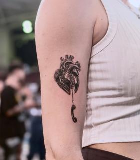 Black and grey realism zipper heart phone tattoo by @dahoonietattoo