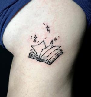 Fine line magical book tattoo by @angie_needs_ink