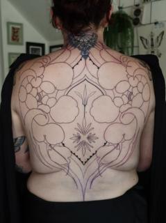 Ornamental blackwork ornamental backpiece tattoo by @ariannamcgradytattoo