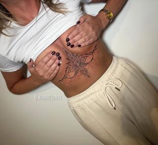 Fine line blackwork ornamental flower tattoo by @wonkyclonky
