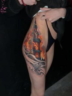 Realism burning castle tattoo by @benjaminlaukis
