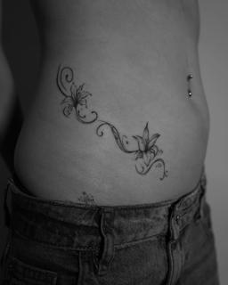 Fine line floral vine tattoo by @kwom.tattoos
