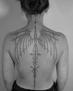 Ornamental linework gothic wings tattoo by @kwom.tattoos