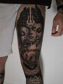 Black and grey realism buddha faces lotus tattoo by @inkside1812