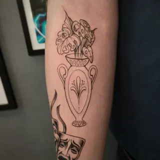 Fine line vase with leaves tattoo by @skibber_tattoo