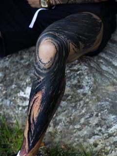Blackwork abstract swirl tattoo by @charliegatestattoo