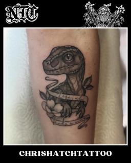Blackwork dinosaur with flower tattoo by @chrishatchtattoo