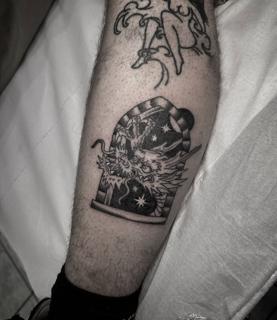 Blackwork dragon in bottle tattoo by @radntrad.tattoos