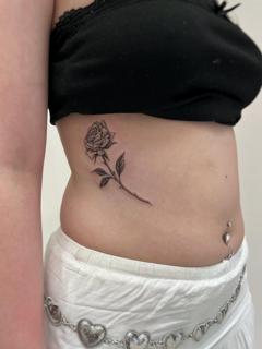 Fine line rose tattoo by @clairedaisytattoos