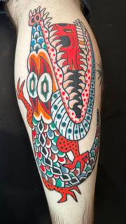 Traditional colorful dragon tattoo by @denotattoo