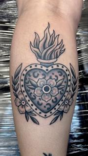 Traditional flaming heart tattoo by @derrythtattoos