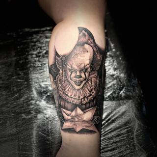 Realism creepy clown tattoo by @divineeyetattoo