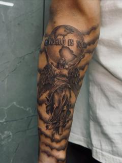 Realism angel globe tattoo by @_drag.tats