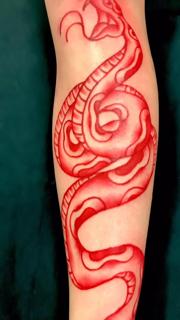 Traditional red snake tattoo by @edstaplestattooer
