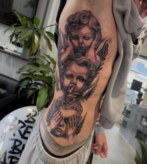Realism cherub faces tattoo by @ellecartelle