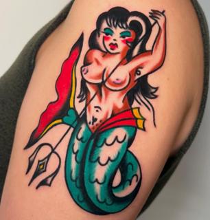 Traditional mermaid pin-up tattoo by @ellie_tattooer