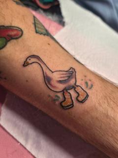 Cartoon traditional goose in boots tattoo by @emmaelizabethtattoo