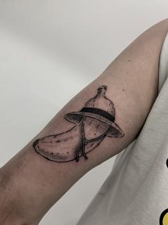 Illustrative banana with hat tattoo by @xema.tattoos