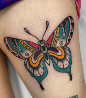 Traditional colorful butterfly tattoo by @fontascast