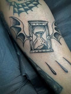 Blackwork hourglass with wings tattoo by @george_thirst