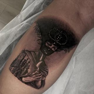Realism masked figure tattoo by @kazatattoos