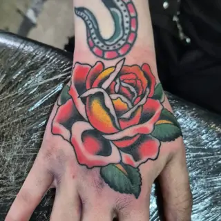 Traditional traditional rose tattoo by @georgiamarshalltattoo