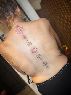 Fine line lotus moon spine tattoo by @gee_tattoos_uk