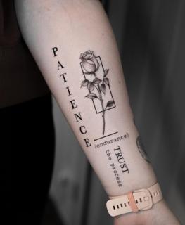 Fine line rose with text tattoo by @griff.tattoo
