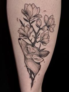 Blackwork deer with flowers tattoo by @helle.ink