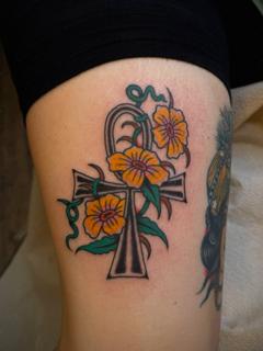 Traditional floral ankh tattoo by @hollyashbytattoo