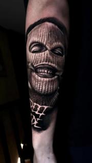 Realism masked face tattoo by @ilias_lab