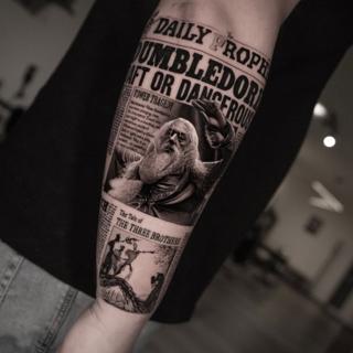Realism newspaper portrait tattoo by @inalbersekov