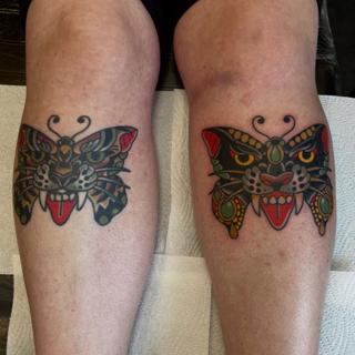 Traditional butterfly panther tattoo by @jamiegreavestattooer