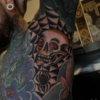 Traditional skull and spider tattoo by @jamiegreavestattooer