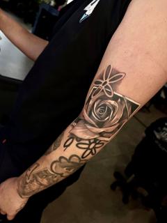 Black and grey realism rose and geometric shapes tattoo by @whoisjaybanq