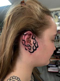 Blackwork flame ear tattoo by @jen_mogg_tattoo