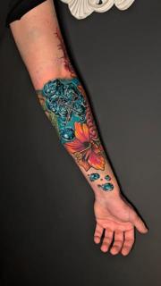 Color realism floral skull tattoo by @jim.tat