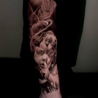 Realism cherub and bird tattoo by @jodiestarktattoo