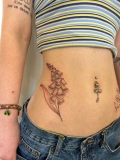 Fine line floral stem tattoo by @joelclementstattoo