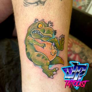 Cartoon cartoon dinosaur tattoo by @heartanddagger.tattoo
