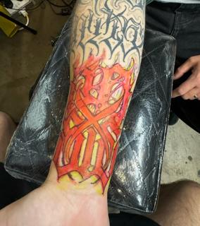 Color realism flaming symbol tattoo by @niorkz