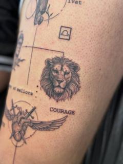 Fine line lion head tattoo by @katcorneytattoo