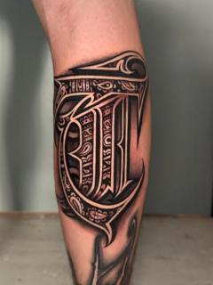 Lettering ornamental letter tattoo by @kingsley_hayward
