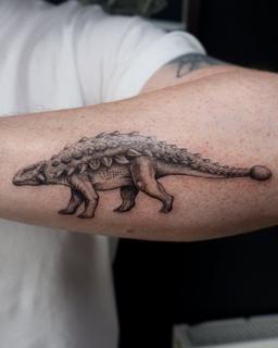 Dotwork armored dinosaur tattoo by @libertyctattoo