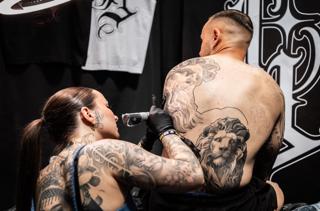 Realism lion and figure tattoo by @lisa__ink
