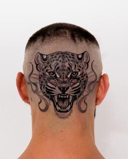 Blackwork leopard head tattoo by @lozzarachtattooer
