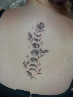 Fine line moon phases floral tattoo by @lucky_lou_tattoos